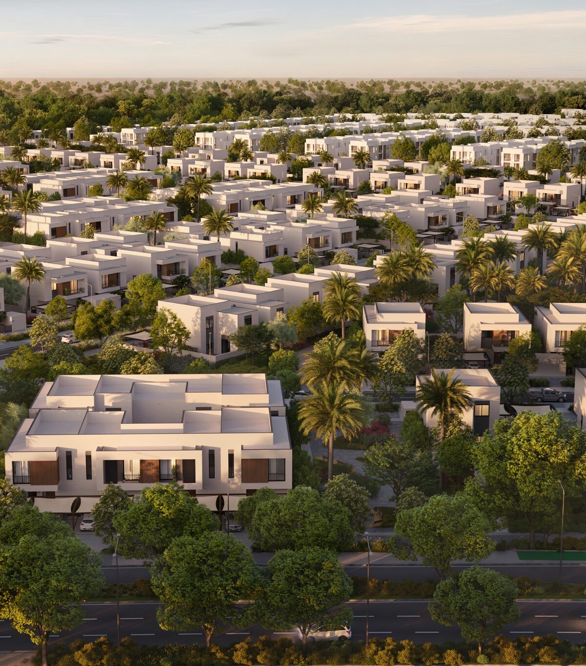 Aerial view of Al Ghadeer Parks by Aldar showing townhouses set among landscaped gardens