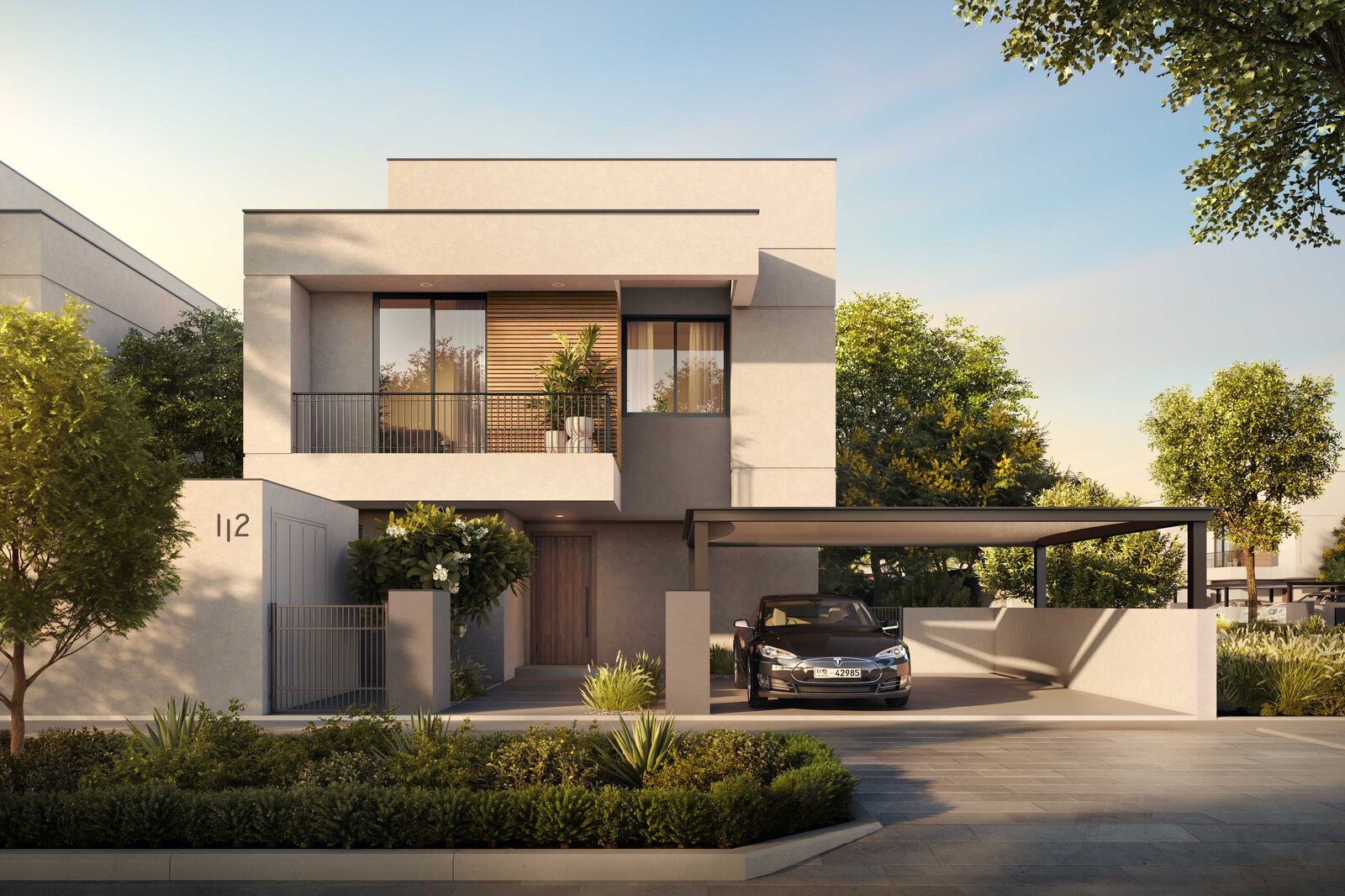 Townhouse facade with covered parking at Al Ghadeer Parks by Aldar