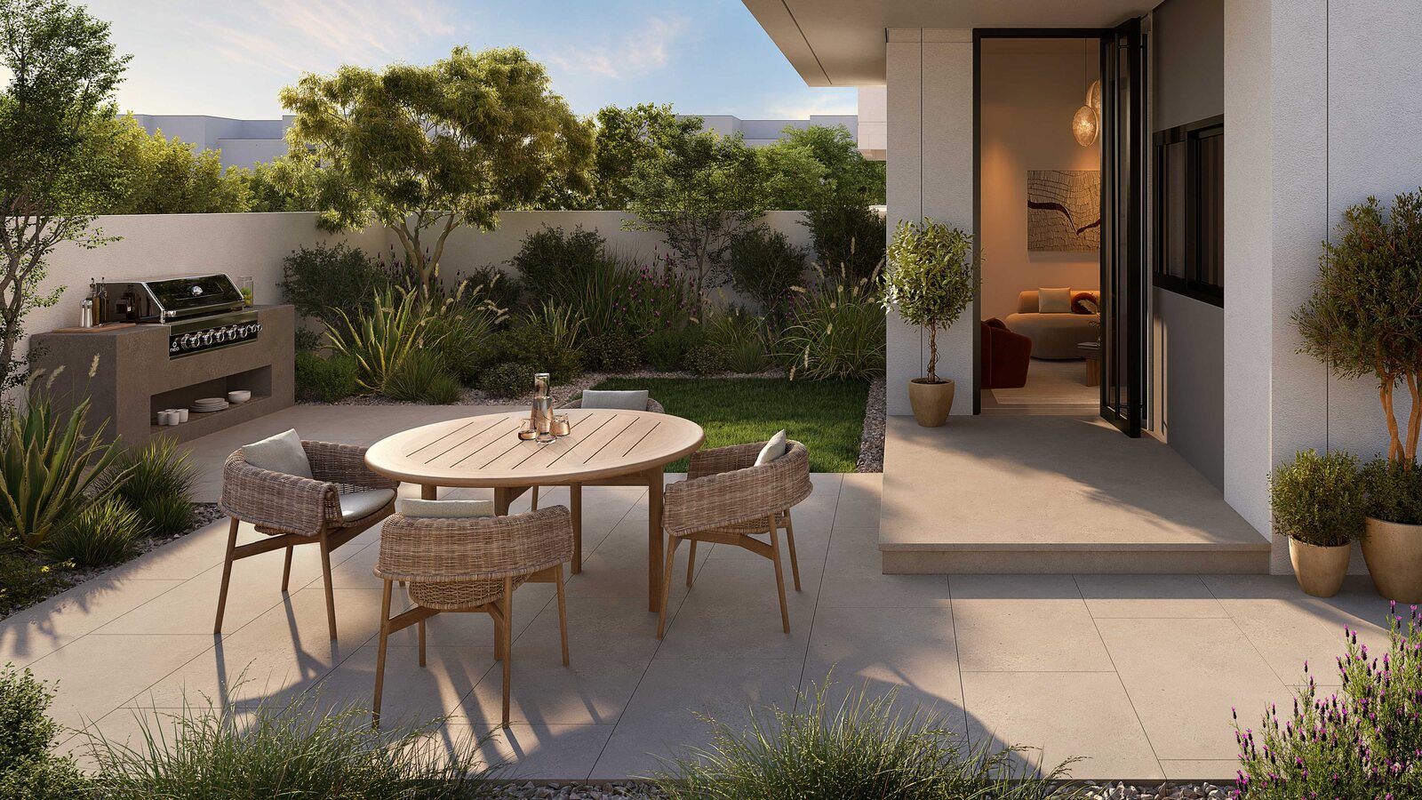 Private garden terrace with outdoor dining at Al Ghadeer Parks by Aldar